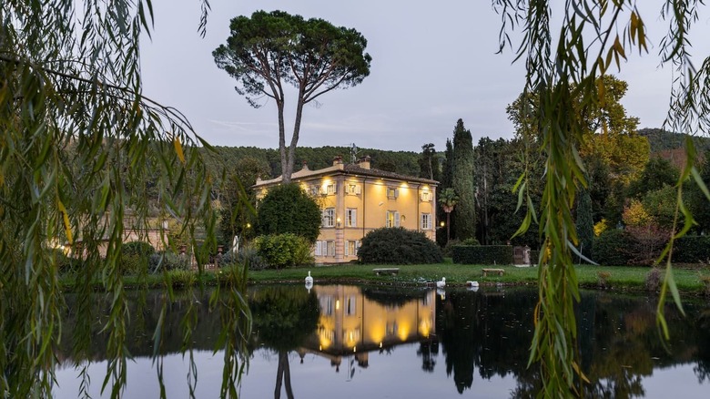 mansion reflecting in a lake