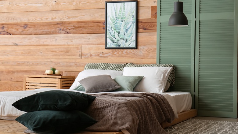 Earth-toned bedroom with wood panels