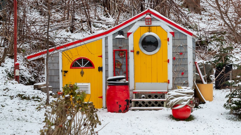 a shed with bright yellow and red accents 