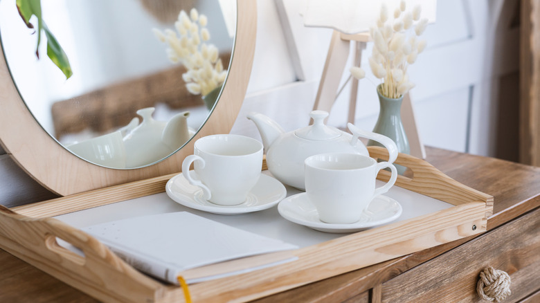 Tea set and notebook on tray