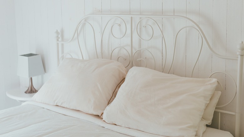 Thin white metal bed frame