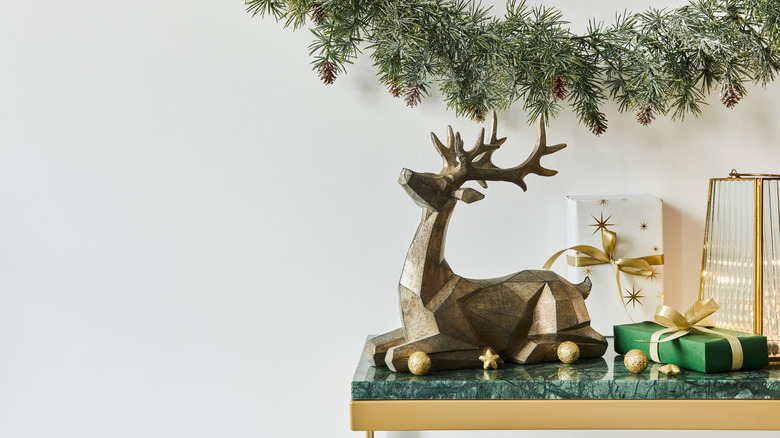 metallic deer statue on table