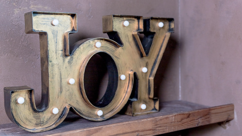 gold joy sign with lights