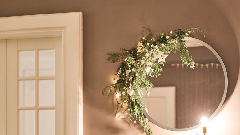 green garland around round mirror