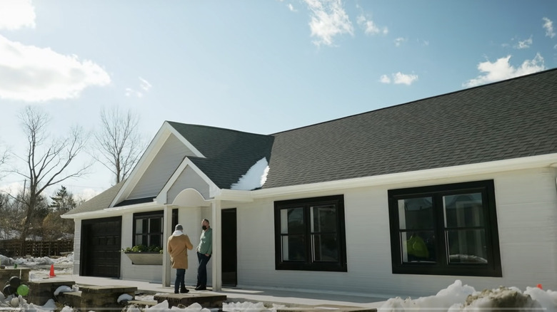 two men outside ranch-style house