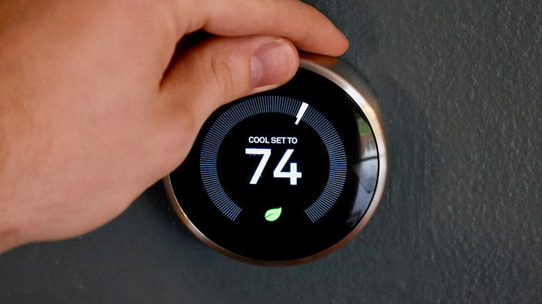 hand adjusting smart thermostat