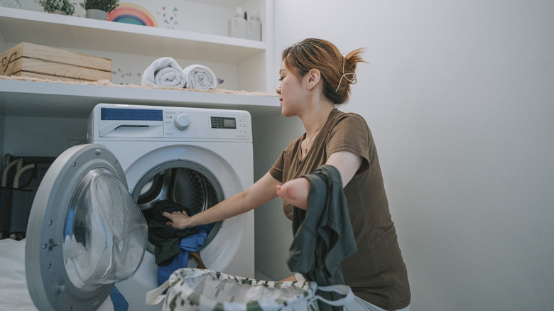 woman loading washing machine
