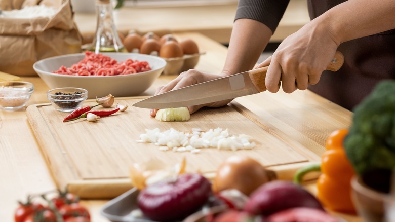 chopping vegetables on cutting board