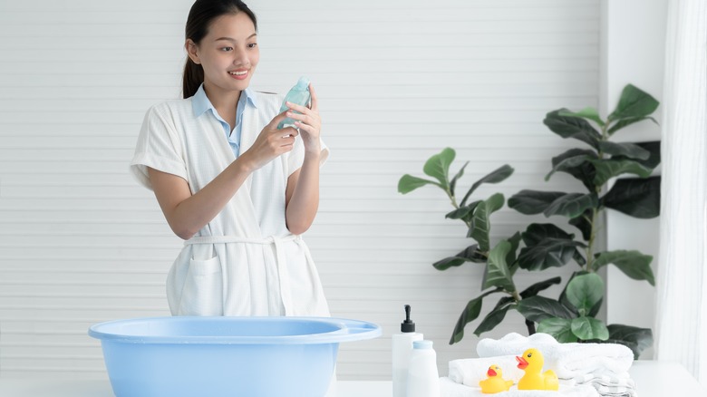 woman reads cleaning product label