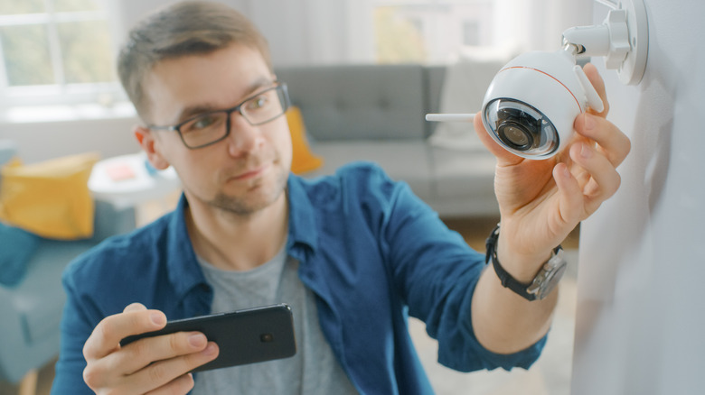 Man adjusting security camera