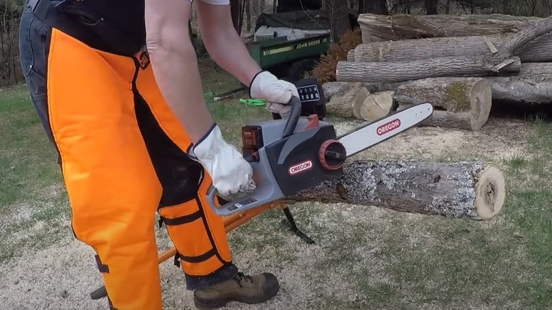 Man cutting logs with an Oregon chainsaw