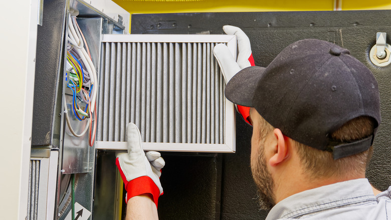 A man changing a furnace filter