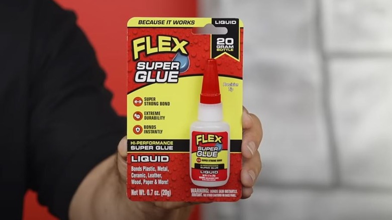 Man holding Flex Super Glue package