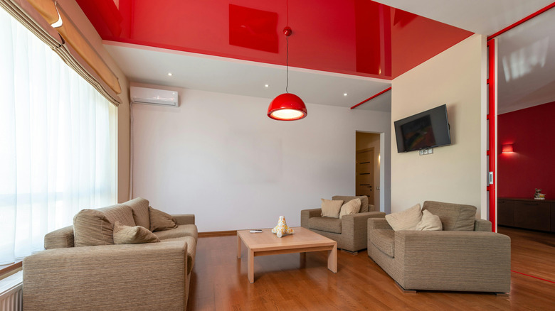 Living room with a red ceiling and white walls