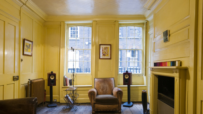 Living room with yellow walls, ceiling, and fireplace