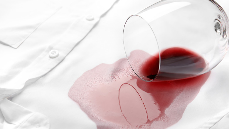 Red wine spilling on white shirt