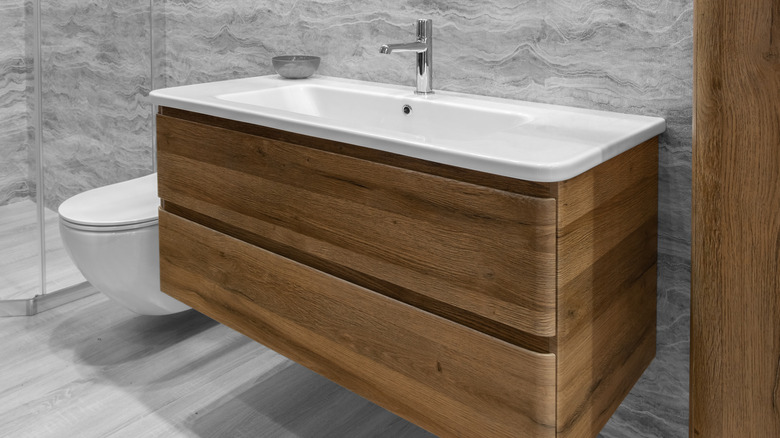 white sink with wood base