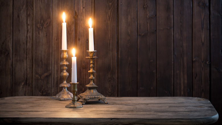 gold candlesticks with lit candles