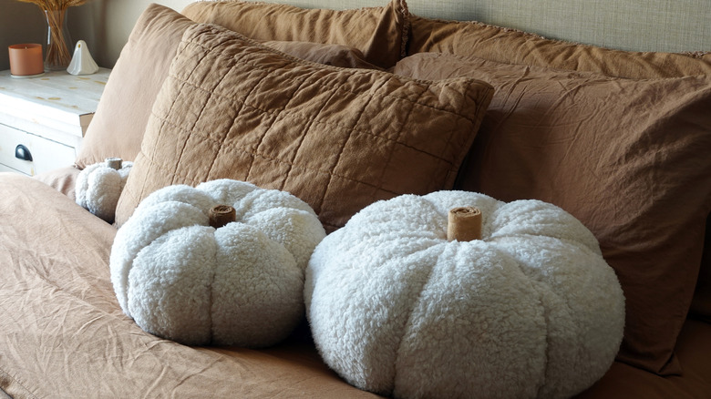 stuffed pumpkins on brown bedding