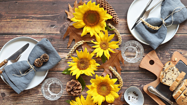 sunflowers with leaves on table