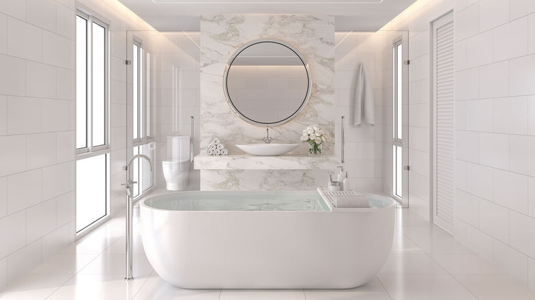 White bathroom with marble and freestanding tub