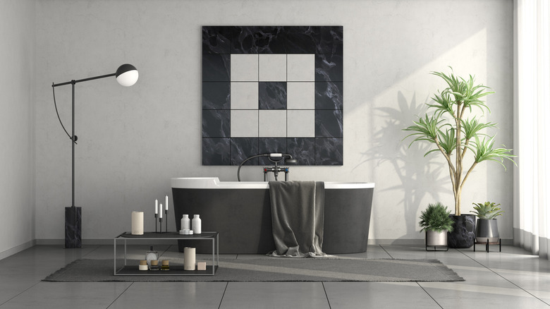 Dark gray tub and art in modern bathroom