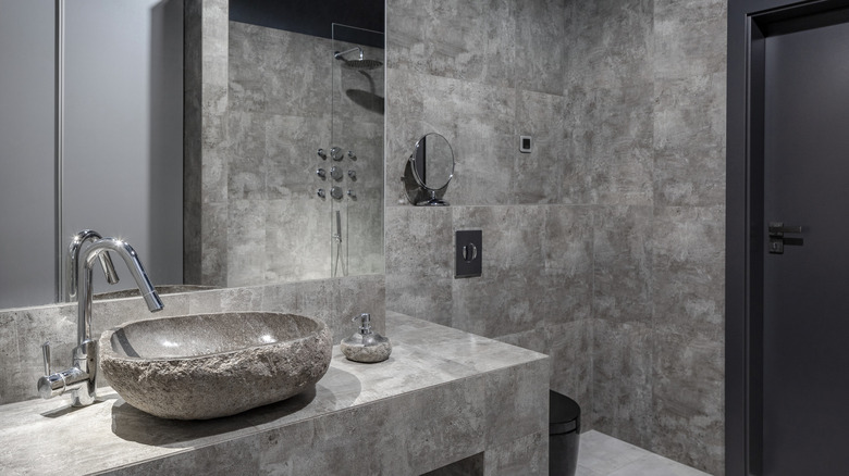 Gray bathroom with rustic stone sink