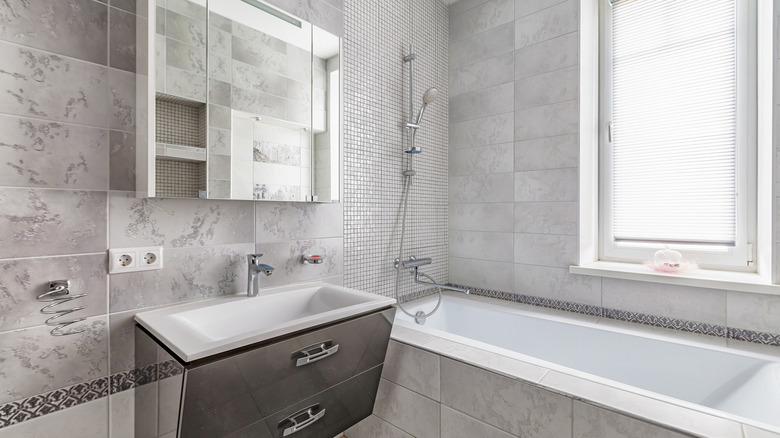 Bathroom with various gray tiles