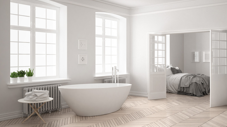 Chic white bathroom with large windows