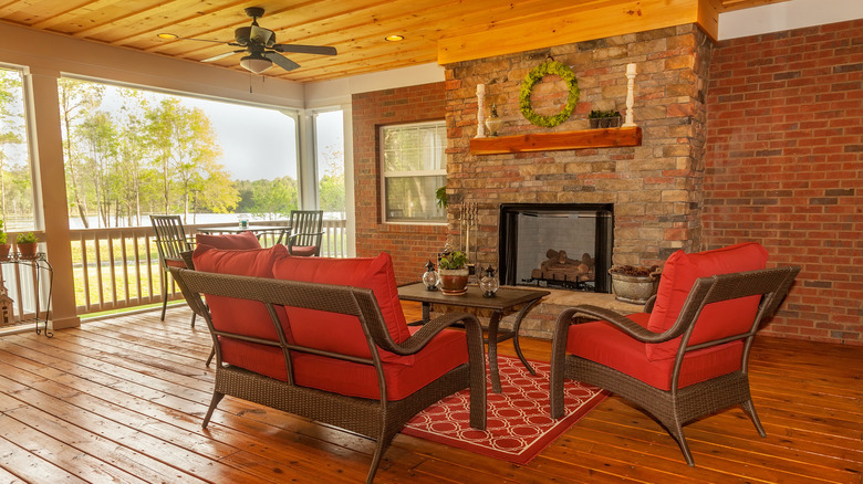 covered deck with brick fireplace