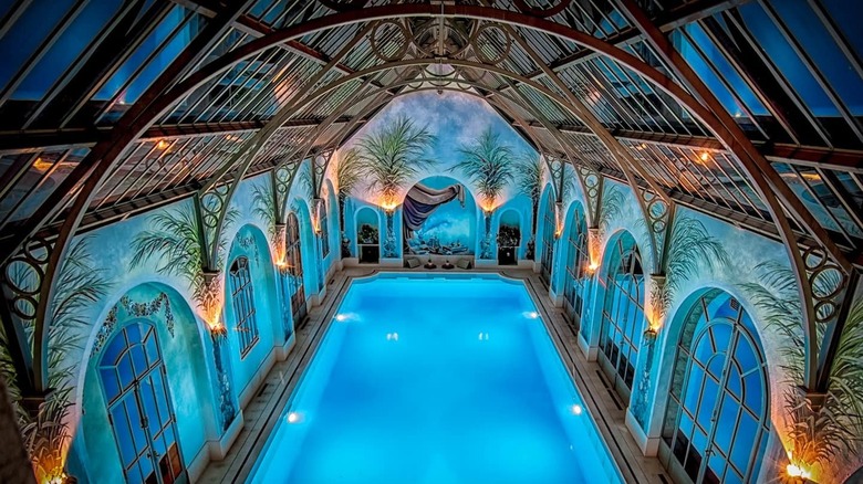 indoor pool with ornate ceiling
