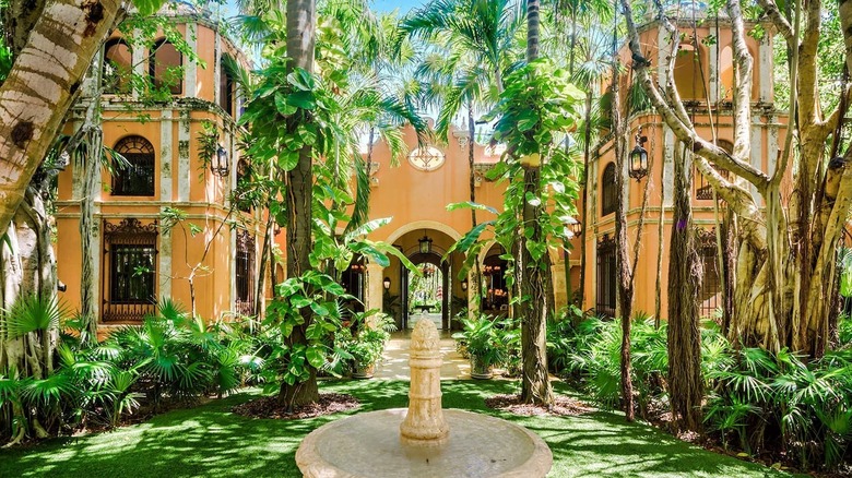 rose-colored mansion with plants