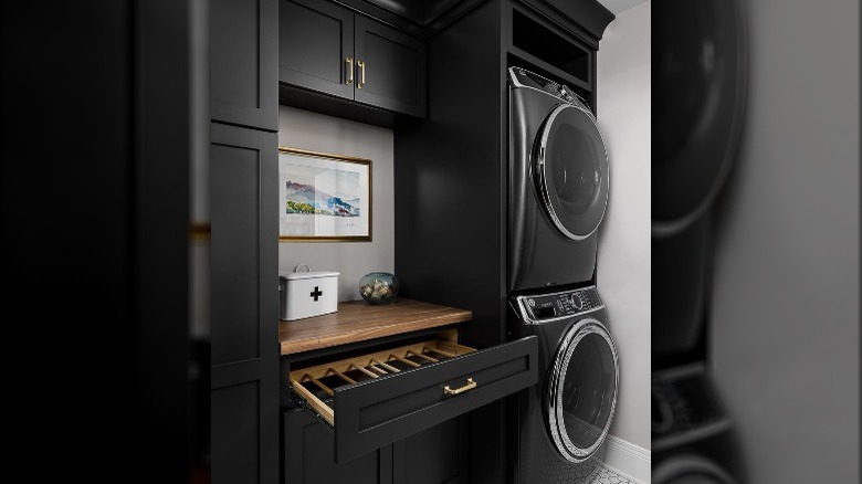 Black, gold, and wood laundry room