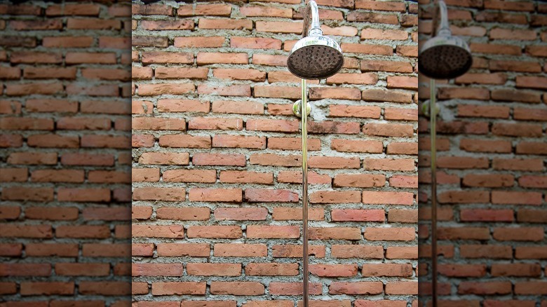 outdoor shower on brick wall