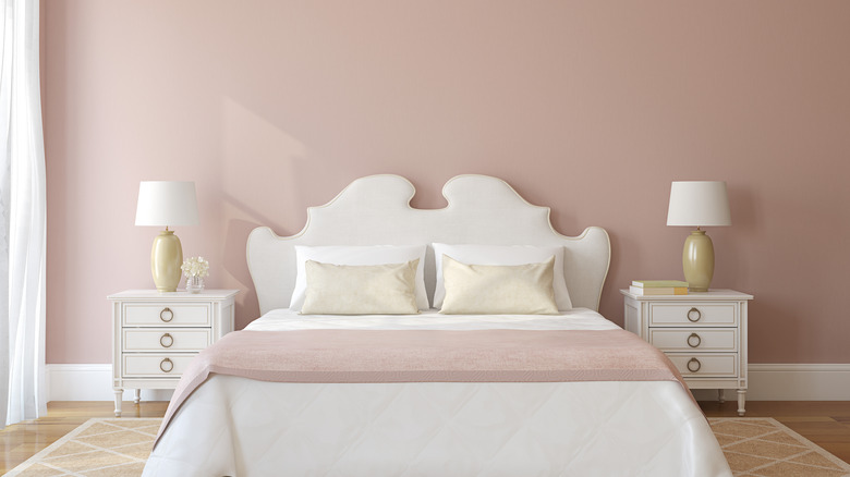 Pink bedroom with white headboard
