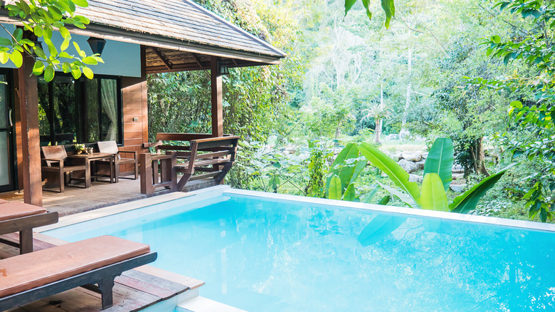 a pool house in the forest 