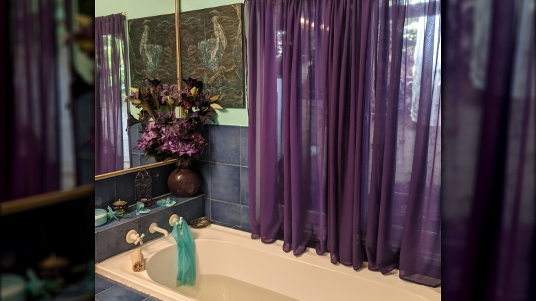 Purple curtains bathtub window