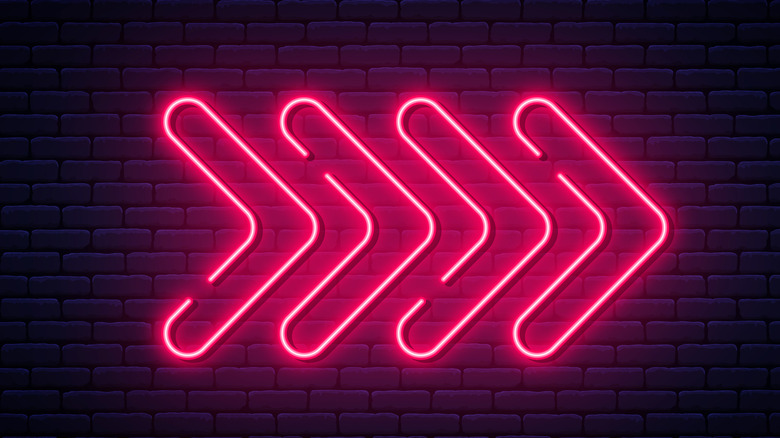 fuchsia neon sign with arrows