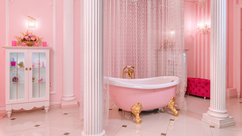 fuchsia ottoman in pink bathroom