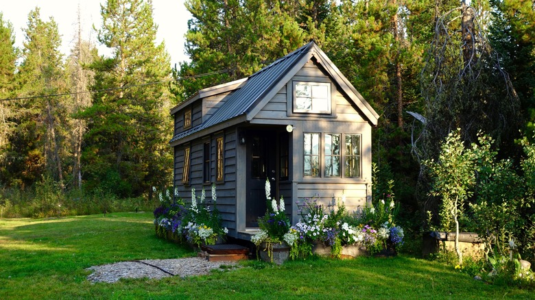 small grey cabin with flowers