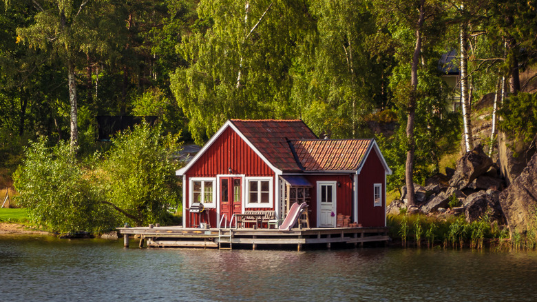 red cabin on the water