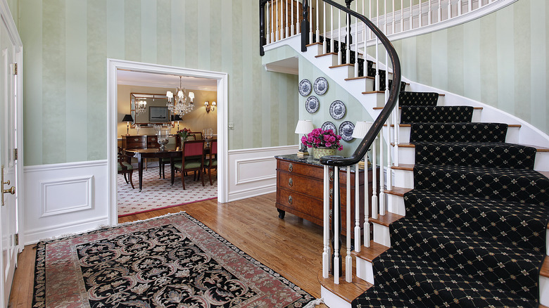 Luxury home with carpeted staircase