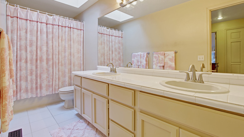 bathroom with pink shower curtain