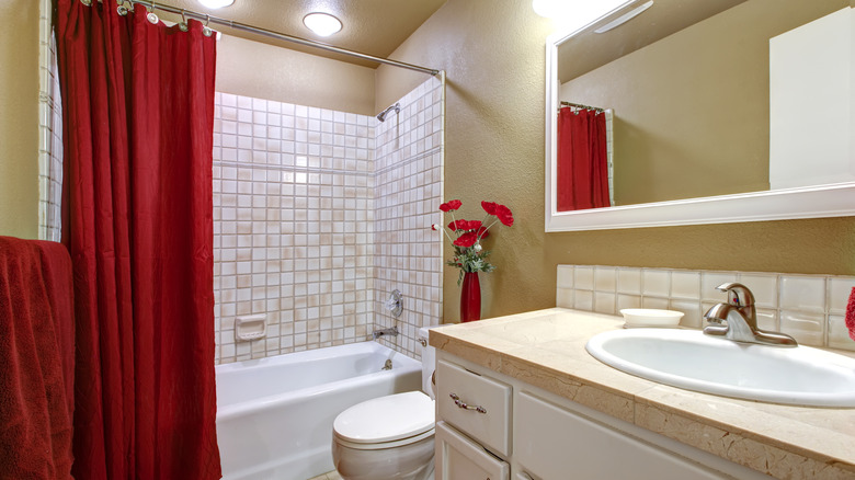 bathroom with red accents