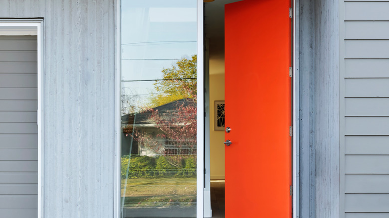 gray home with orange door 