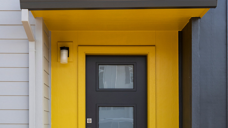 yellow home with gray door 