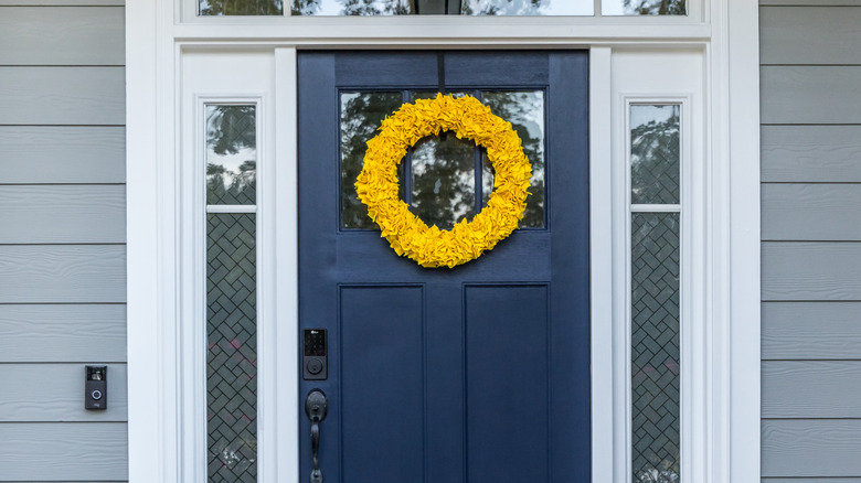 navy door with yellow wreath 