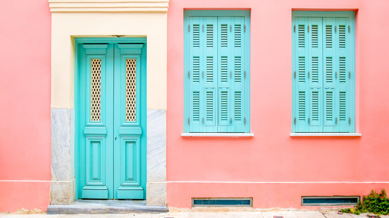 bright pink house with turquoise doors 