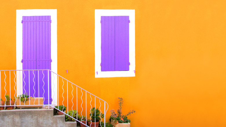 yellow home with purple doors 