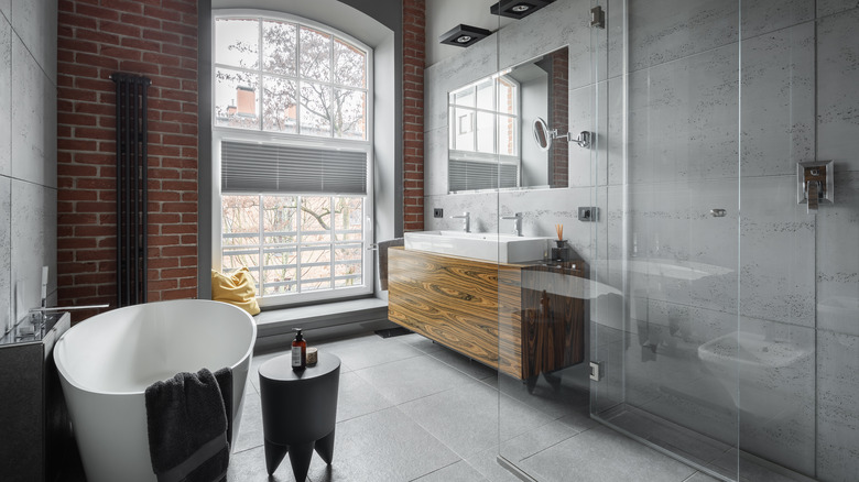 bathroom with exposed brick wall 